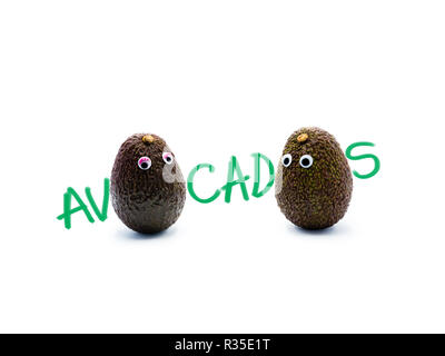 Romantic avocados couple with googly eyes as man and woman, funny food concept for creative projects. Stock Photo