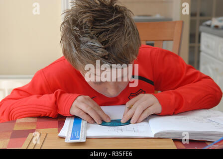 Nine Year Old Boy doing his homework Stock Photo