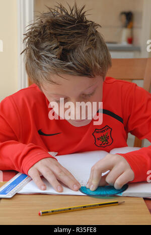 Nine Year Old Boy doing his homework Stock Photo
