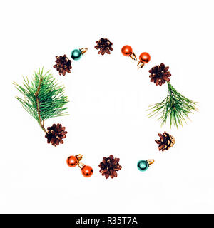 Isolated Christmas composition Flat lay Decorative round composition with Christmas balls, pinecones and fir-tree branches on white background Stock Photo