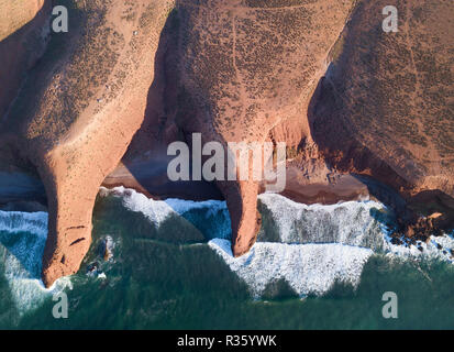 Aerial top view on Legzira beach with arched rocks on the Atlantic coast at sunset in Morocco Stock Photo
