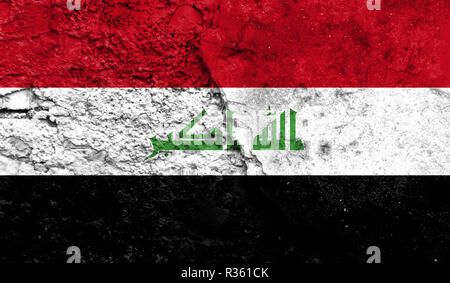 Flag of Iraq close up painted on a cracked wall, concept of armed actions and conflicts in the world Stock Photo
