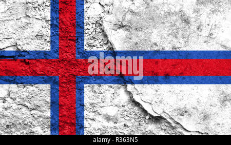 Flag of Faroe Islands close up painted on a cracked wall, concept of armed actions and conflicts in the world Stock Photo