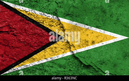 Flag of Guyana close up painted on a cracked wall, concept of armed actions and conflicts in the world Stock Photo