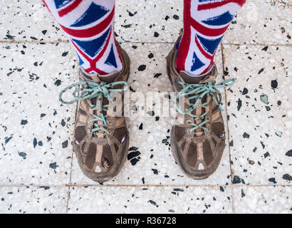 Well worn trainers and union jack socks on textured background Stock Photo