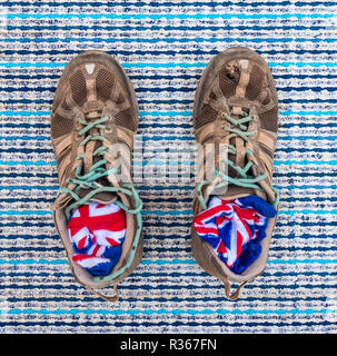 Well worn trainers and union jack socks on textured background Stock Photo