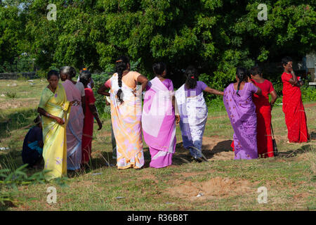 Mahabalipuram, India - September 3, 2007: Indian women dressed in colorful traditional fsari and preparing to attend an open air celebration event in  Stock Photo