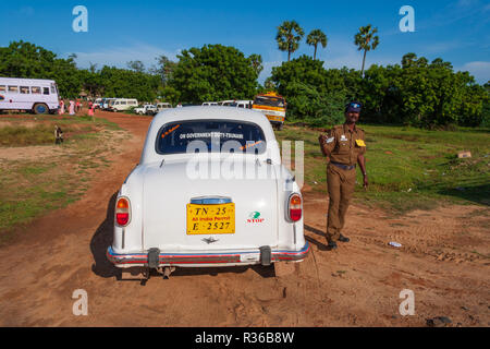 Mahabalipuram, India - September 3, 2007: Indian policeman next to a car policing an open air celebration event in Mahabalipuram. Stock Photo