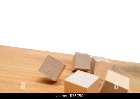 Wooden cubes roll on an inclined plane. Stock Photo