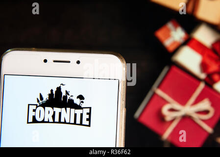 Epic Games Company Logo On A Website With Blurry Stock Market Developments In The Background Seen On A Computer Screen Through A Magnifying Glass Stock Photo Alamy