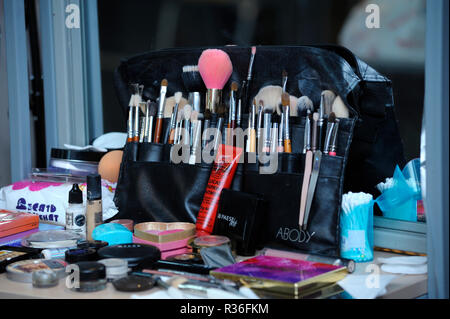 At a beauty salon. Make-up professional kit placed on working table: brushes, tubes, lipsticks, sprays, cosmetic sticks. Kiev,Ukraine. November 8,2018 Stock Photo