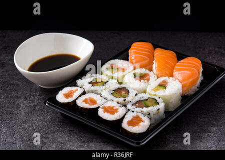 sushi assortment on black tray and soy sauce Stock Photo