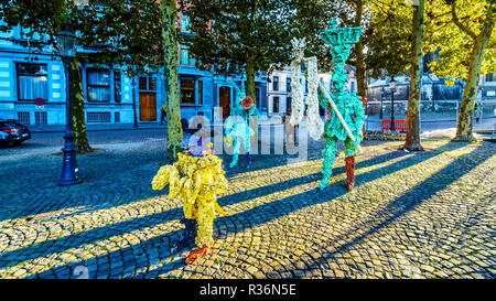 Sculptures made from hard resin by artist Han van Wetering and dedicated to carnival. On the Vrijthof square in the historic city of Maastricht Stock Photo