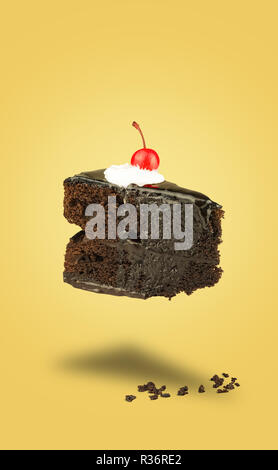 Isolated Chocolate cherry cake flying on yellow background. Chocolate pie. Flying brownie with cream. Stock Photo