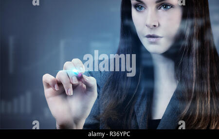 Portrait of a young businesswoman writing on a touch board Stock Photo