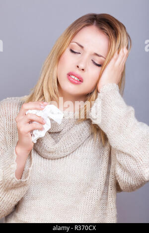 Young sick woman holding her head Stock Photo