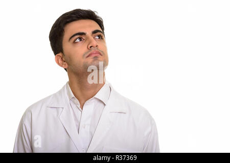 Young handsome Persian man doctor thinking and looking up Stock Photo
