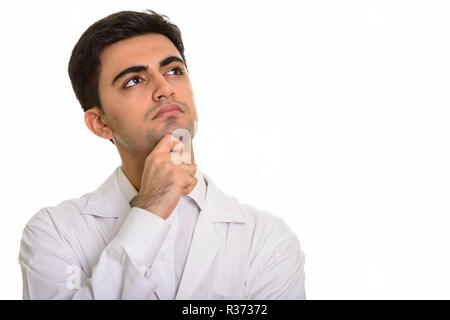 Young handsome Persian man doctor thinking and looking up Stock Photo