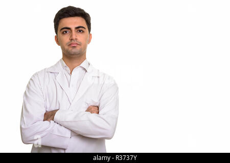 Young handsome Persian man doctor with arms crossed Stock Photo