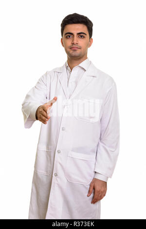 Young handsome Persian man doctor giving handshake Stock Photo
