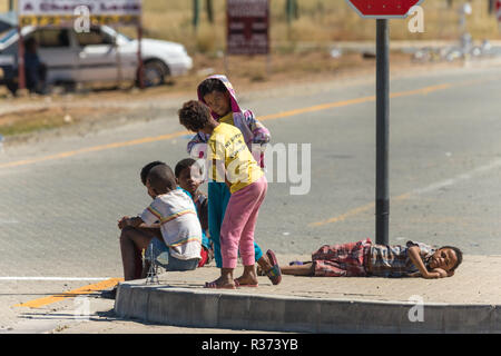 street kids or street children working by selling souvenirs on the side of the road in South Africa Stock Photo