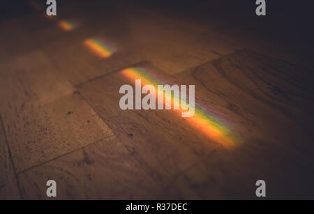 Close up photo of rainbow on wooden floor. Stock Photo