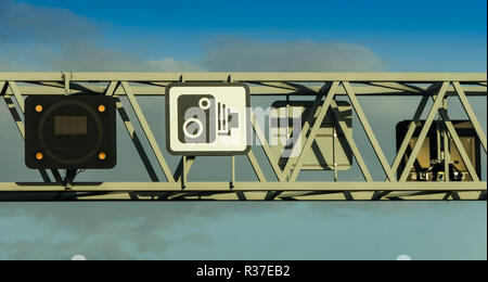 BRISTOL, ENGLAND - NOVEMBER 2018: Close up view of a gantry above the M4 motorway near Bristol. The sign shows traffic cameras are used to enforce spe Stock Photo