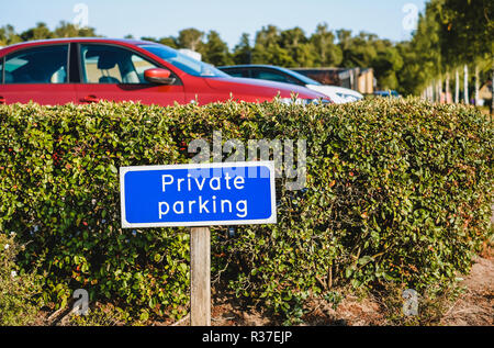 Blue colored sign PRIVATE PARKING at the entrance of car park Stock Photo