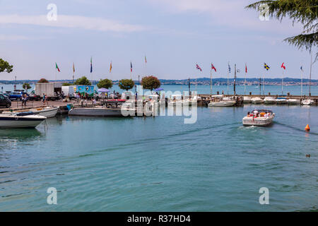 Harbour and boats in Sirmione on Lake Garda in Italy Stock Photo