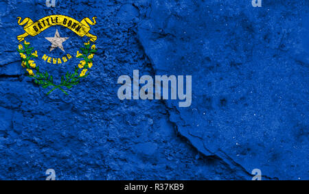 Flag State of Nevada close up painted on a cracked wall, concept of armed actions and conflicts in the world Stock Photo