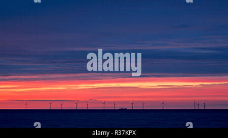 Offshore wind turbines at sunset in Colwyn Bay on the North Wales coast Stock Photo
