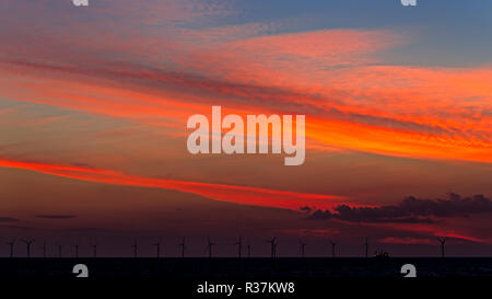 Offshore wind turbines at sunset in Colwyn Bay on the North Wales coast Stock Photo