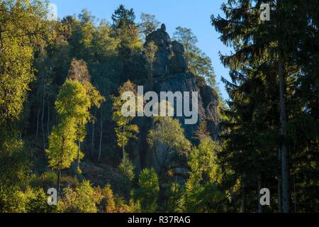 Rock formation in a valley with coloured trees in the Harz Mountains in Germany Stock Photo