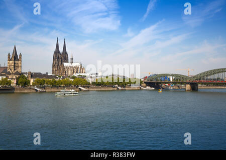 Roman Catholic Gothic Cathedral, Great St. Martin church, main train station and  Hohenzollern Bridge in Cologne, Germany. Stock Photo