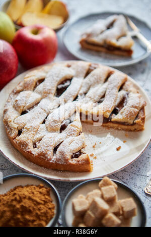 Fresh baked apple pie with cutted slice on small plate Stock Photo