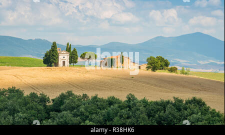 Idyllic landscape with the famous Vitaleta Chapel, in Val d'Orcia, In the italian region of Tuscany. Stock Photo