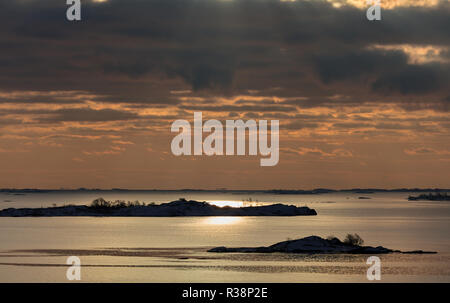 Sun shining from behind clouds, reflecting in the Baltic sea Stock Photo