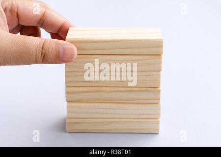 Hand Picking Wood Blocks - Business Concept. Stock Photo