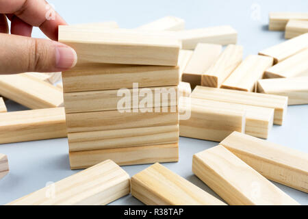 Hand Picking Wood Blocks - Business Concept. Stock Photo