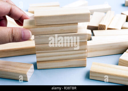 Hand Picking Wood Blocks - Business Concept. Stock Photo