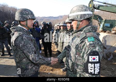 Koreas connect road inside heavily fortified DMZ South Korea's Vice Defense Minister Suh Choo-suk (L) shakes hands with a soldier near an unpaved road that crosses the Military Demarcation Line inside the Demilitarized Zone (DMZ) in the central section of the inter-Korean border in Cheorwon, Gangwon Province, on Nov. 22, 2018. The two Koreas connected the 3-kilometer-long road at Arrowhead Ridge, a site of fierce battles in the 1950-53 Korean War, the same day to support a joint project to excavate remains of soldiers who died in the three-year conflict. (Pool photo) (Yonhap)/2018-11-22 17:10: