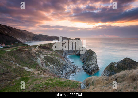 Lulworth Cove, Dorset, UK.  22nd November 2018. UK Weather.   Stair Hole at Lulworth Cove on the Dorset Jurassic Coast shortly after sunrise.  The eroded limestone at Stair Hole shows the scars of dramatic geological events which crumpled the rock strata.  Picture Credit: Graham Hunt/Alamy Live News Stock Photo