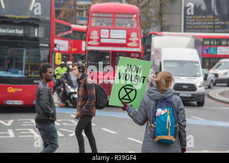 London UK 22nd November 2018 Climate change activists from the Extinction Rebellion group block roads at Elephant and Castle in protest that the government is not doing enough to avoid catastrophic climate change and to demand the government take radical action to save the planet. Credit: Thabo Jaiyesimi/Alamy Live News Stock Photo