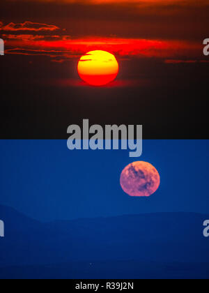 Aberystwyth, Wales, UK. November 22 2018. A double frame image of the the full moon, known this month as the Beaver Moon, rising over the hills outside Aberystwyth , mid Wales, on a freezing cold November night, photographed from the same location where, in the directly opposite direction, and half an hour before,  the sun set spectacularly through the clouds  photo credit: Keith Morris / Alamy Live News Stock Photo