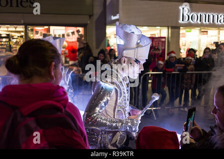 Lisburn, Northern Ireland, 22nd November, 2018. Crowds of people, including many young families, line Bow Street and Market Square in Lisburn city centre to watch a lantern parade involving local schoolchildren accompanied by carnival performers for the annual Christmas Lights Switch-On. It marks the start of Lisburn Light Festival, 22 November - 25 January, when over one million lights will illuminate the city centre. The Mayor, Councillor Uel Mackin switched on the Christmas lights ably assisted by Santa. Credit: Ian Proctor/Alamy Live News Stock Photo