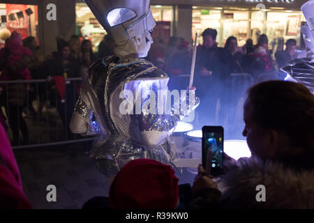 Lisburn, Northern Ireland, 22nd November, 2018. Crowds of people, including many young families, line Bow Street and Market Square in Lisburn city centre to watch a lantern parade involving local schoolchildren accompanied by carnival performers for the annual Christmas Lights Switch-On. It marks the start of Lisburn Light Festival, 22 November - 25 January, when over one million lights will illuminate the city centre. The Mayor, Councillor Uel Mackin switched on the Christmas lights ably assisted by Santa. Credit: Ian Proctor/Alamy Live News Stock Photo