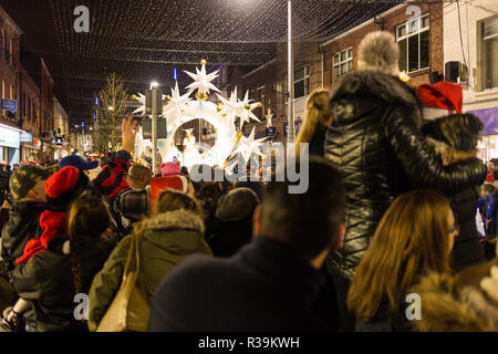 Lisburn, Northern Ireland, 22nd November, 2018. Crowds of people, including many young families, line Bow Street and Market Square in Lisburn city centre to watch a lantern parade involving local schoolchildren accompanied by carnival performers for the annual Christmas Lights Switch-On. It marks the start of Lisburn Light Festival, 22 November - 25 January, when over one million lights will illuminate the city centre. The Mayor, Councillor Uel Mackin switched on the Christmas lights ably assisted by Santa. Credit: Ian Proctor/Alamy Live News Stock Photo