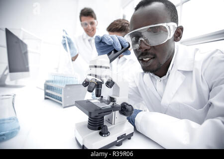 modern scientist uses a microscope in a laboratory Stock Photo