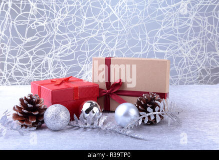 Colorful red gifts with Christmas balls isolated on silver background Stock Photo