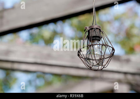 Dirty old light bulb in abandoned barn Stock Photo